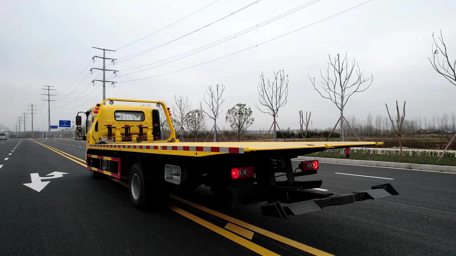 Véritable camion dépanneuse à plateau photographié dans un parc à véhicules