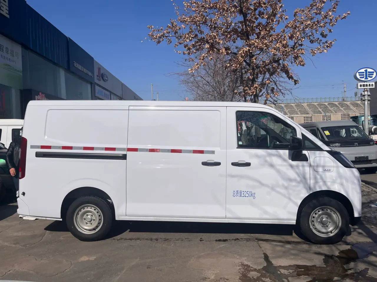 Right-side view of a white closed-panel van with a sliding cargo door