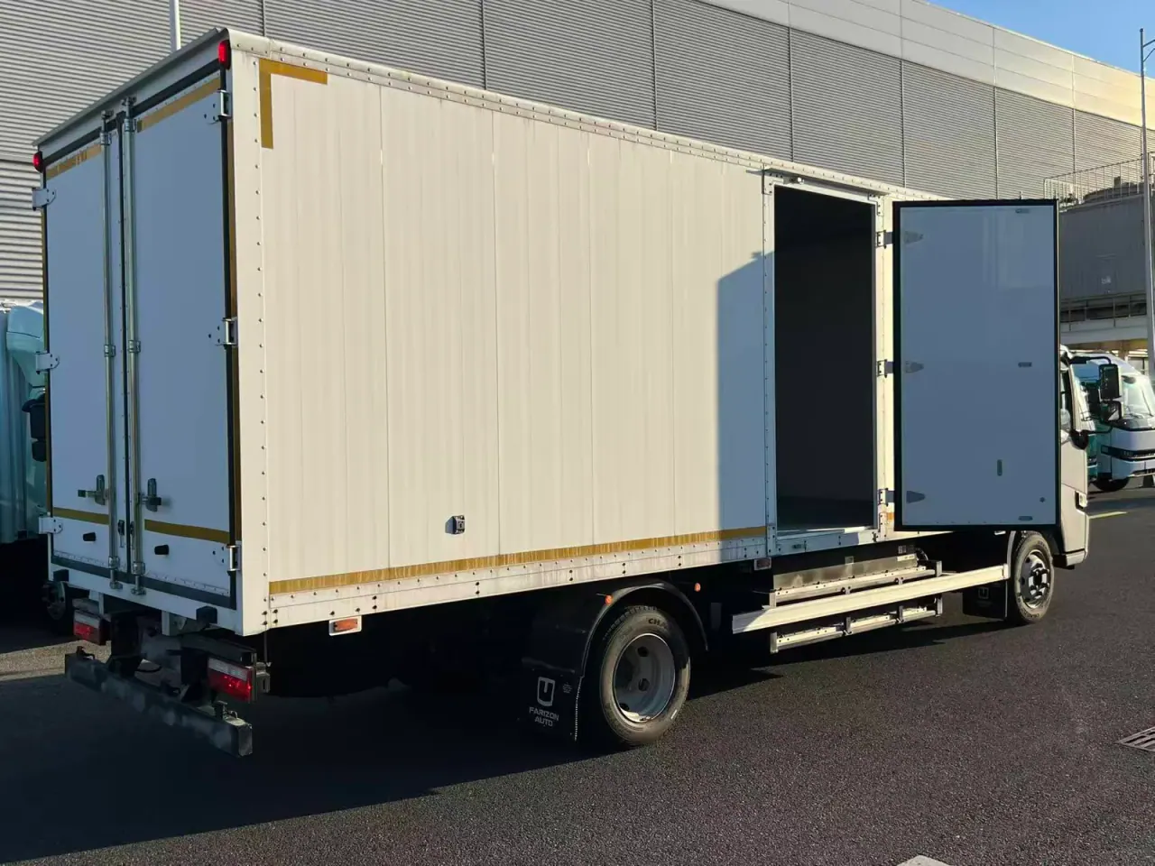 Side and rear view of a white cargo body with a side door open