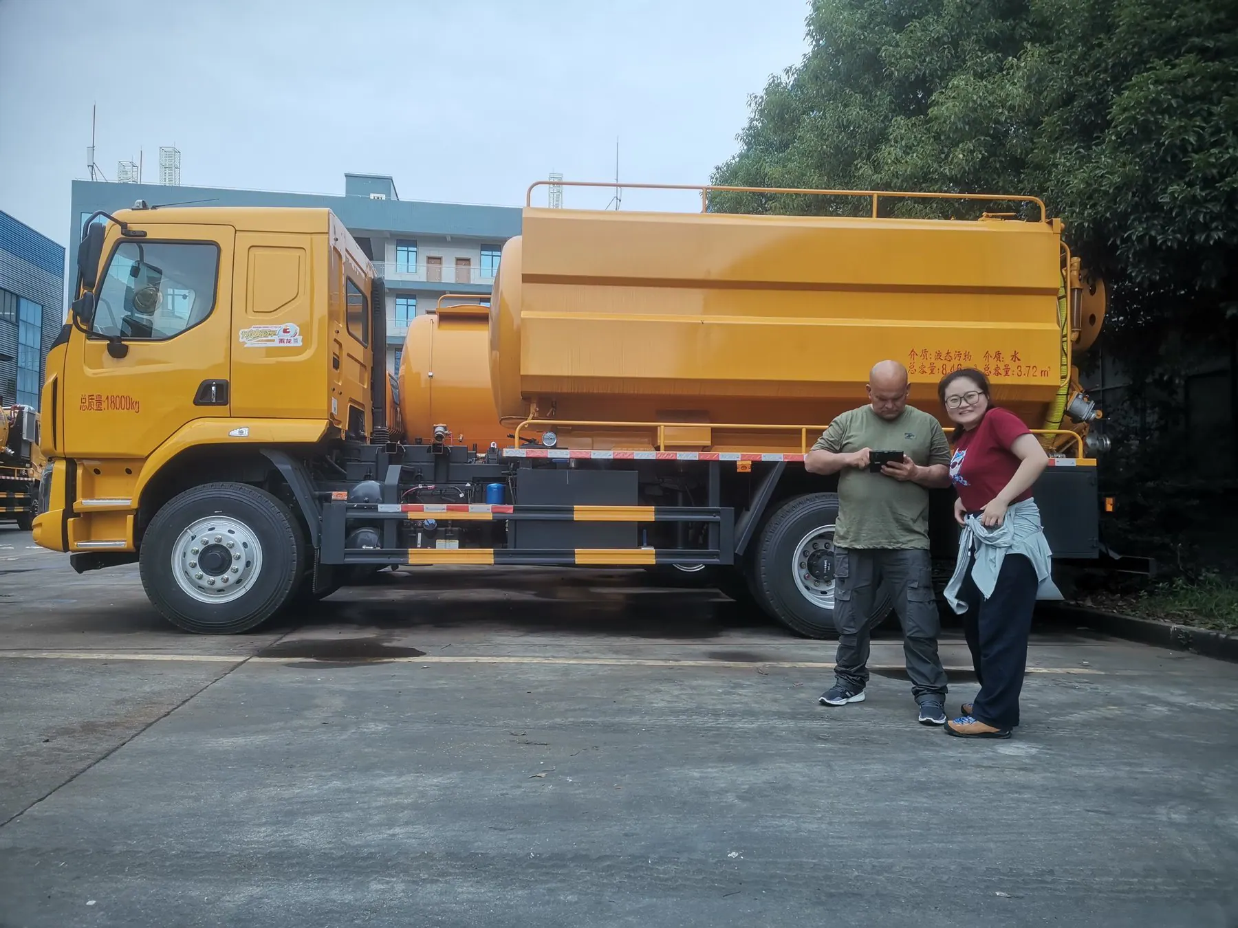 Buyer and project contact reviewing a tanker vehicle in the delivery yard
