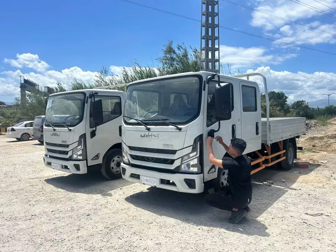 The single-cab and double-cab JMC trucks after collection in Algeria.