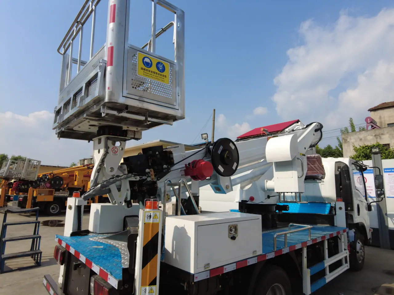Elevated-work basket with safety signage above the rear body