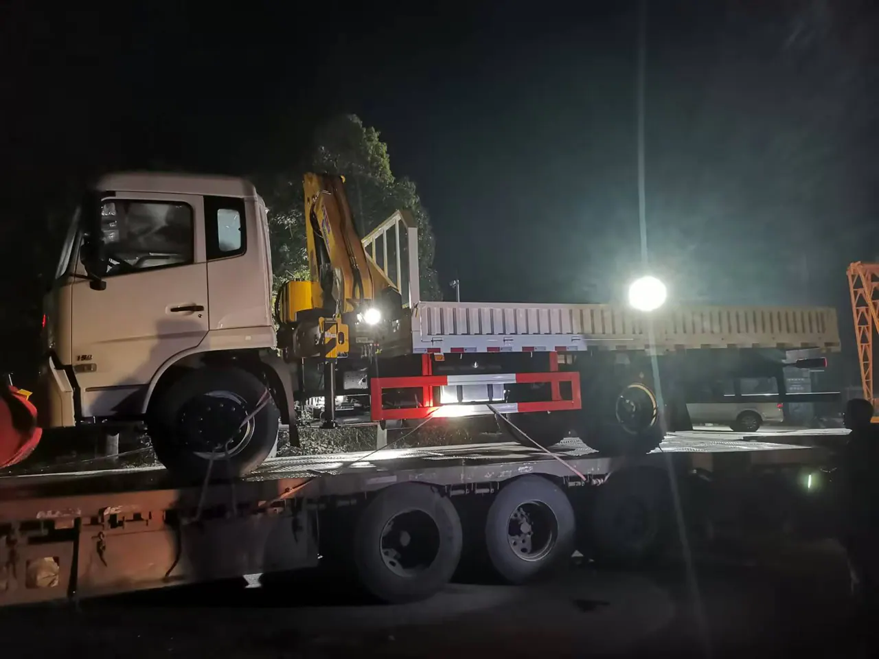 Real truck-mounted crane photographed during loading at night