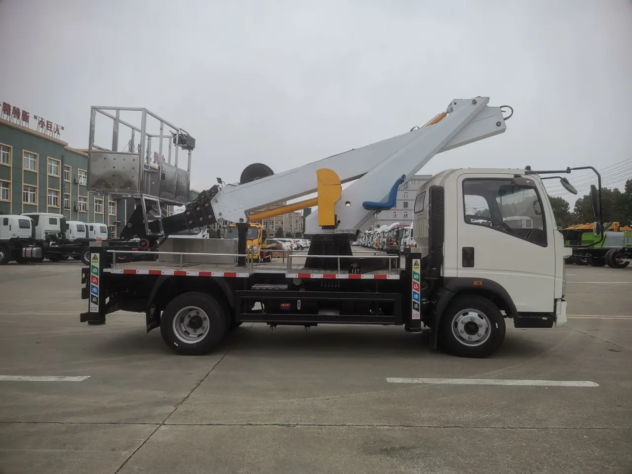 Truck-mounted aerial platform in full side profile with folded boom