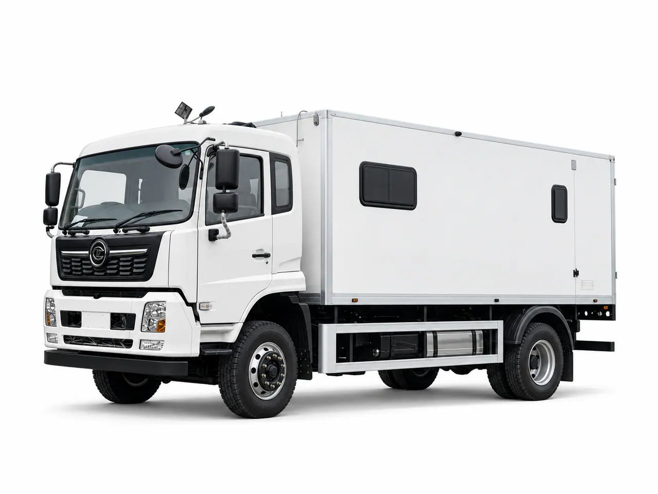 White mobile restroom truck with a box body and small side windows.