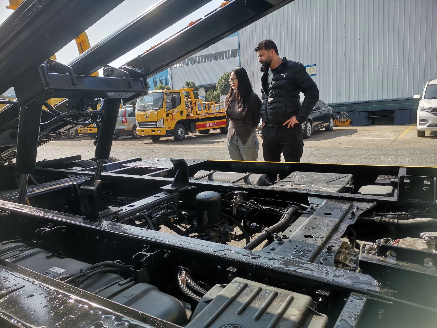 Buyer and project contact reviewing vehicle underbody components