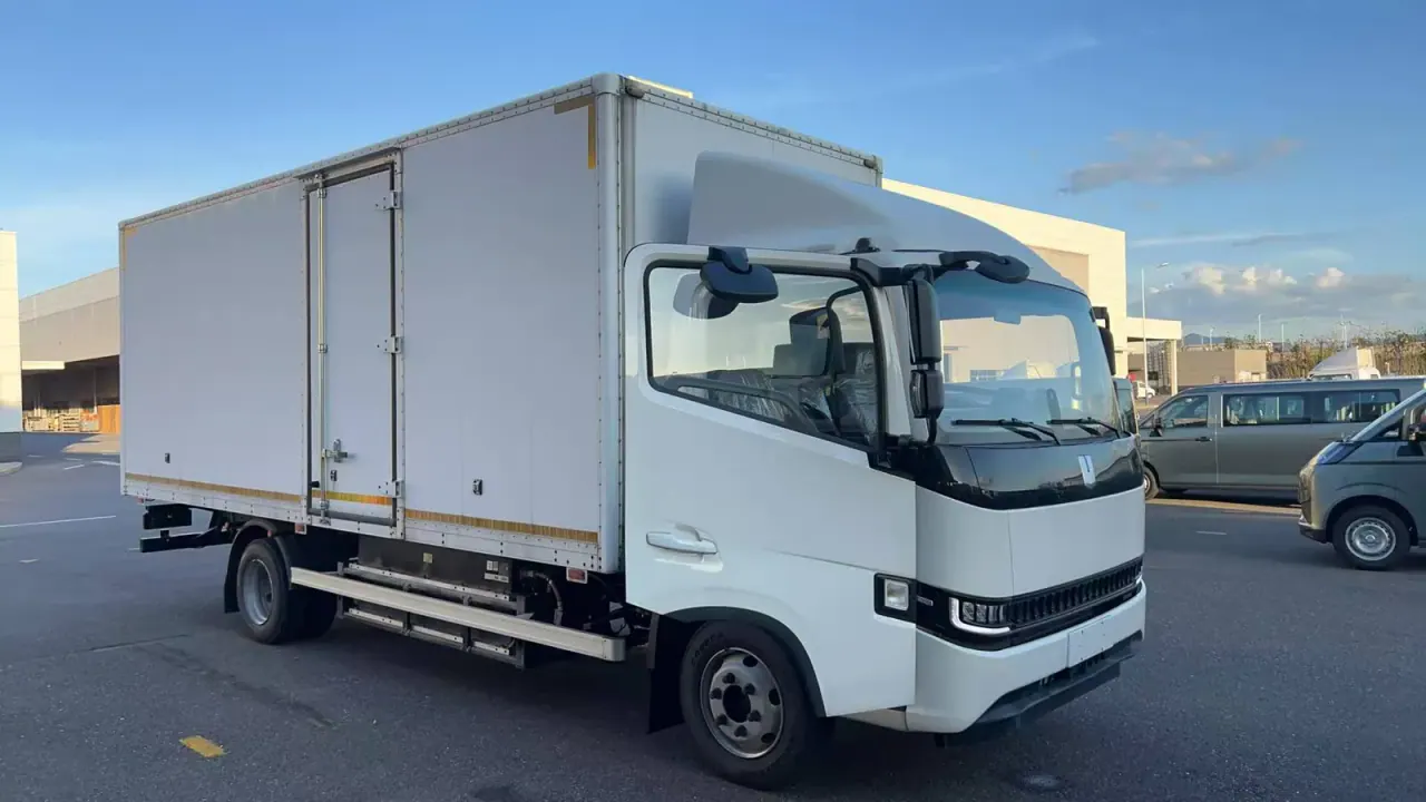 White box truck with an enclosed cargo body and side access door